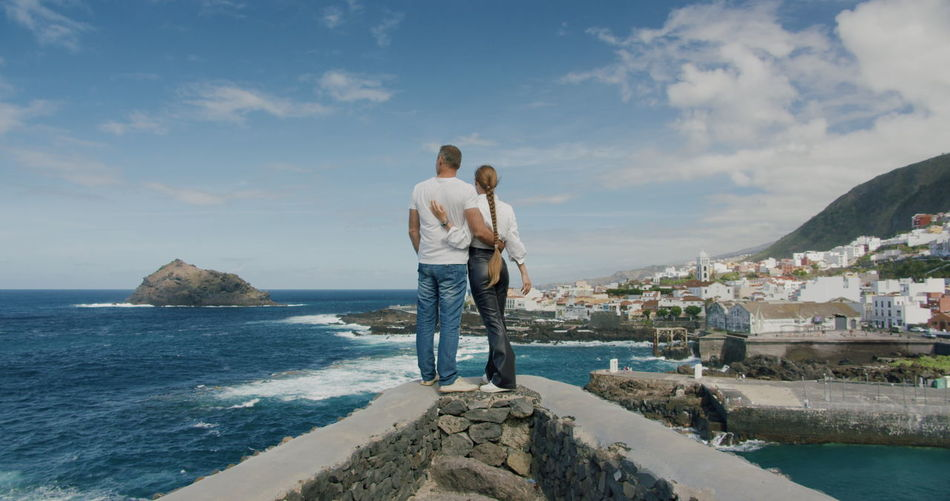 Couple embracing each other. view on ocean beach. vacations on tenerife.