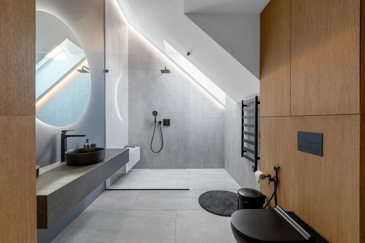 Beautiful elegant modern luxury bathroom interior in luxury home and glass door shower, mirror sink