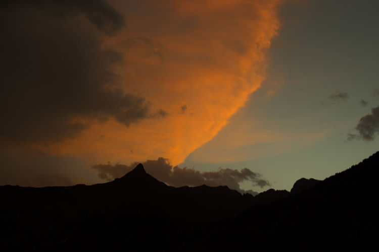 Silhouette of mountain range at sunset