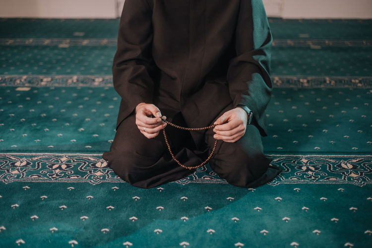 Low section of man sitting on floor