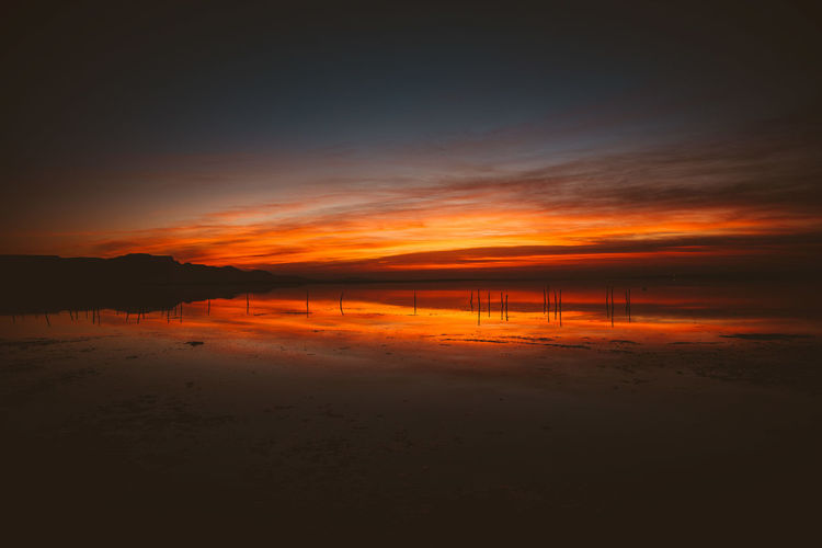 Scenic view of beach against sky during sunset
