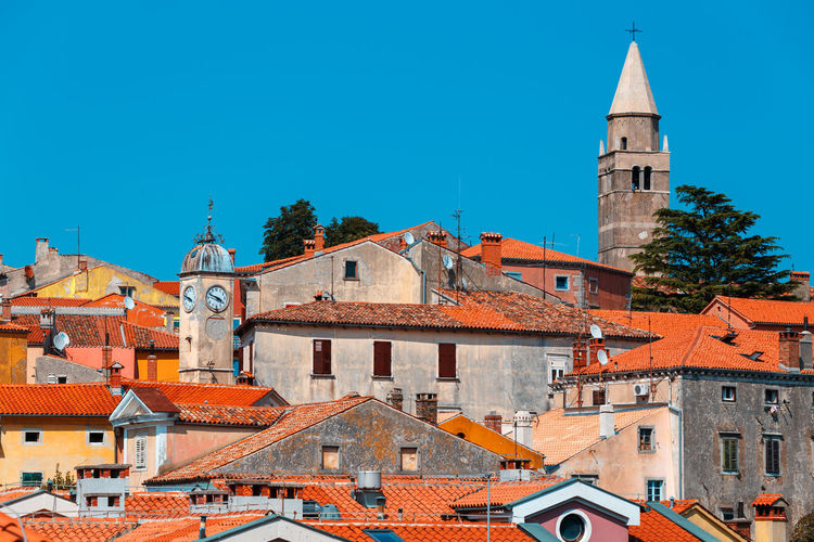 Buildings in town against clear sky