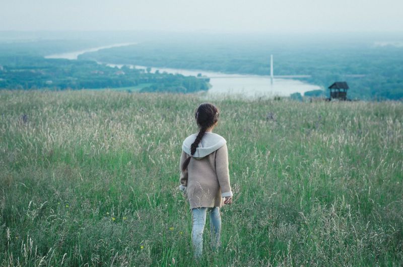 Rear view of woman looking at field