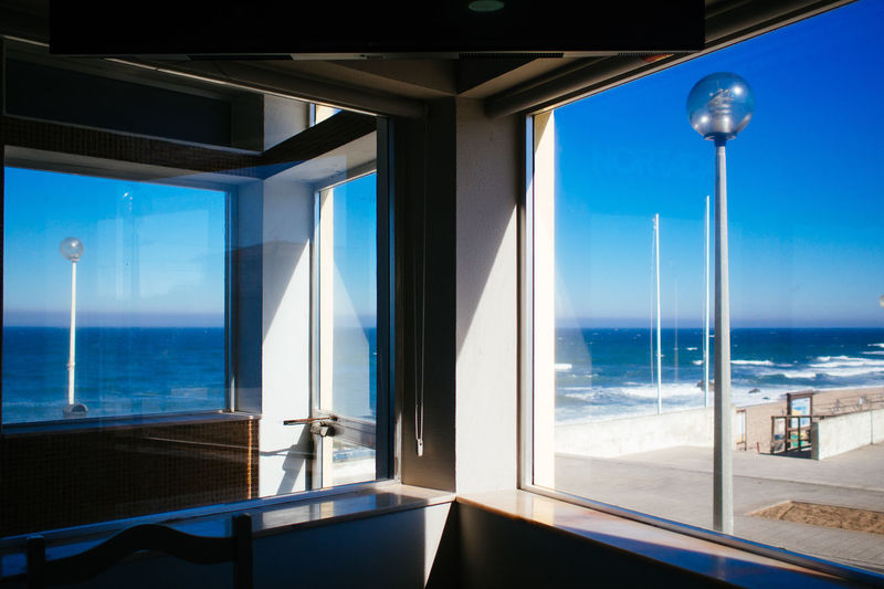 Sea seen through glass windows in restaurant
