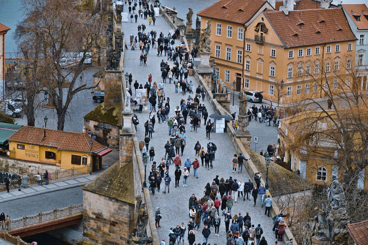 High angle view of people walking on street amidst buildings in town