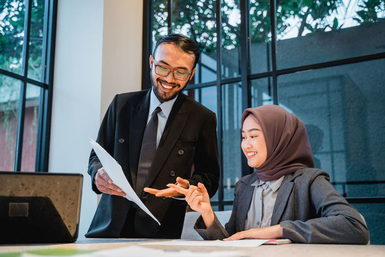 High angle view of smiling man talking with woman