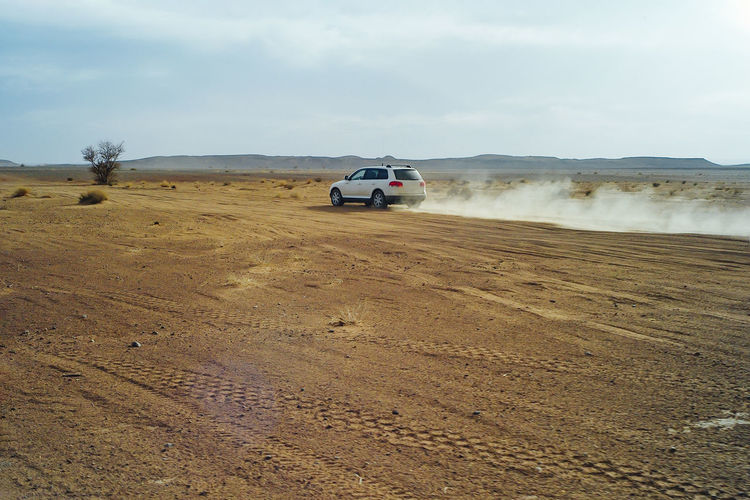 A 4x4 car at high speed through the desert of morocco