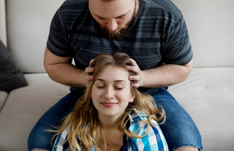 Boyfriend giving girlfriend head massage at home