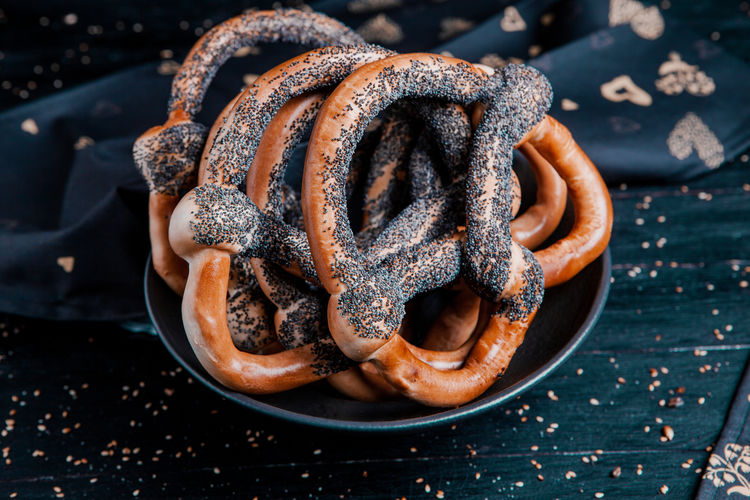 Fresh prepared homemade soft pretzels. different types of baked bagels 