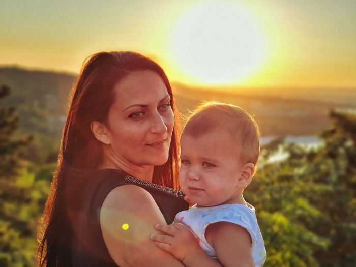 Portrait of mother and daughter during sunset