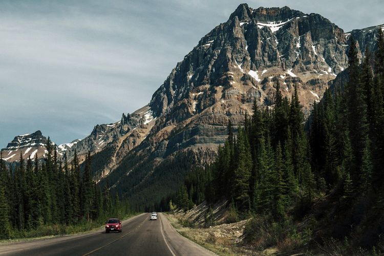 Cars on road against mountain range