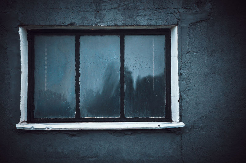 Close-up of window on abandoned house