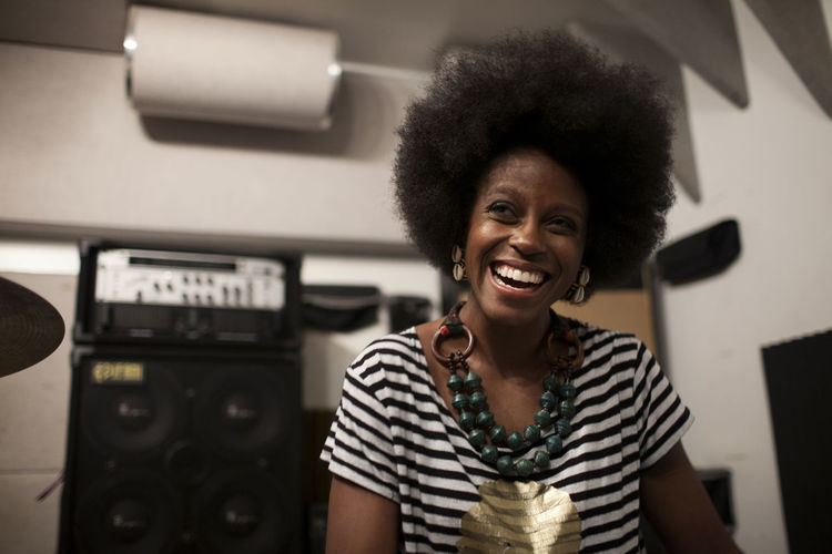 Portrait of a smiling woman in a music studio