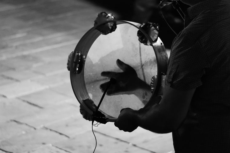 High angle view of man playing guitar on street