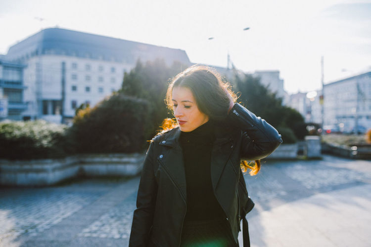 Young woman standing in city during winter