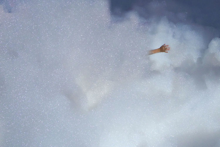 Woman swimming in water against sky