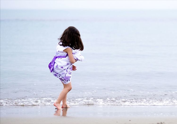Girl standing at beach