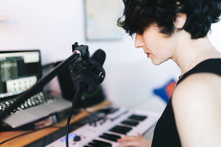 Female musician composing in studio