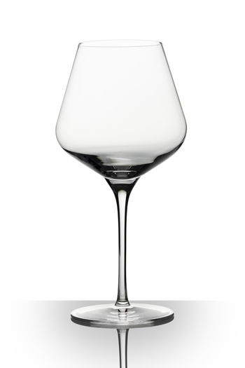 Close-up of wineglass against white background