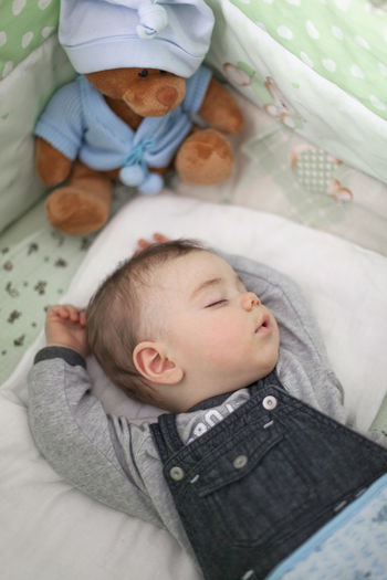 High angle view of cute baby sleeping on bed