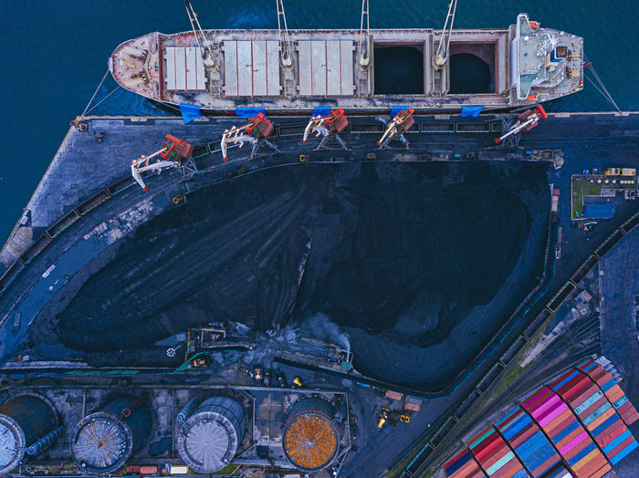 Russia, primorsky krai, vladivostok, aerial view of industrial ship moored in coal loading dock
