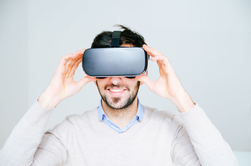 Midsection of man using virtual reality simulator