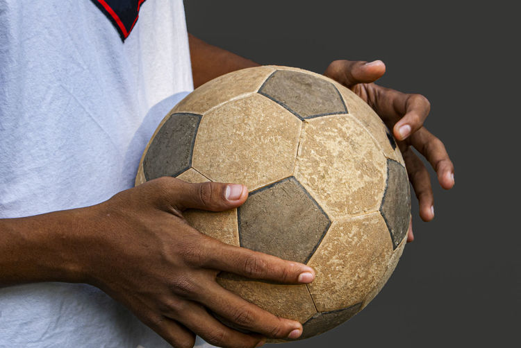 Midsection of man playing soccer ball