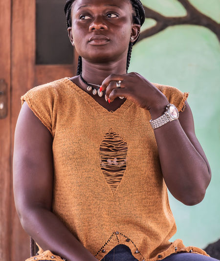 African woman from ghana looking at something in the village of ada foah west africa