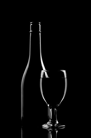 Glass of wine against black background