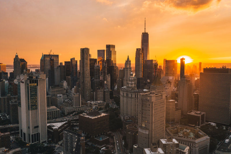 Uptown manhattan in golden hour sunset light with skyline of skyscrapers drone shot