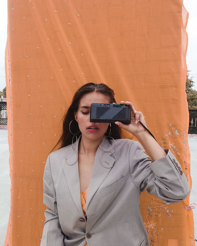 Young woman photographing camera