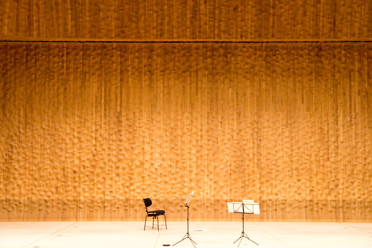 Empty orchestra stage against orange backdrop