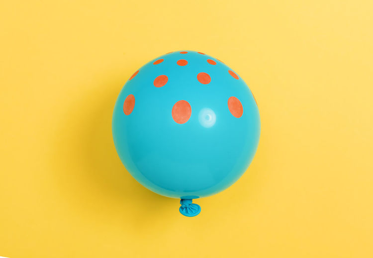 Close-up of balloons against yellow background