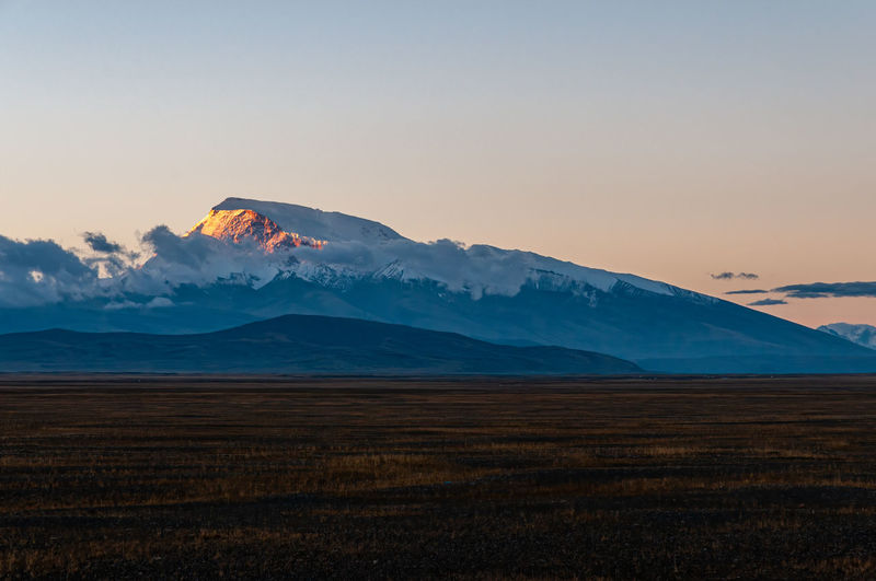 Scenic view of volcanic landscape against sky during sunset