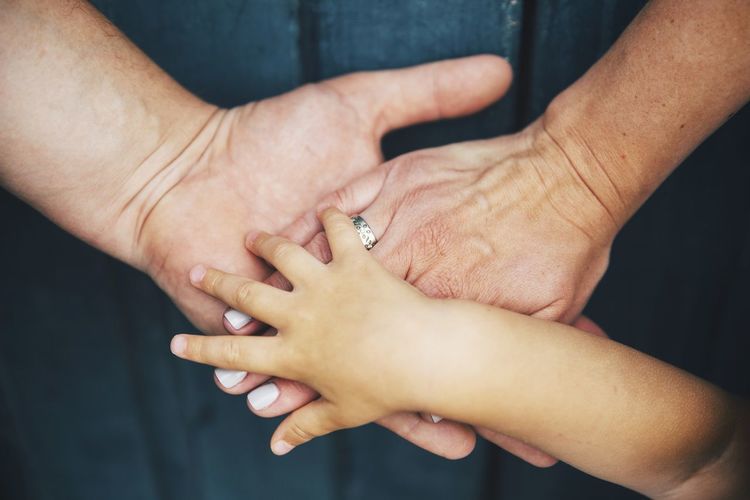 Close-up of family stacking hands