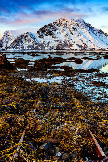 Frozen lake against mountain range