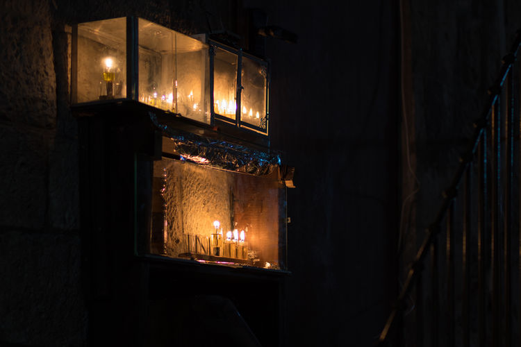 Hanukkah candles are lit at the entrance to a building in the jewish quarter of jerusalem