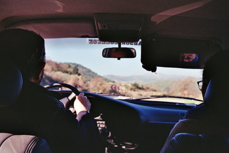 Rear view of man driving car