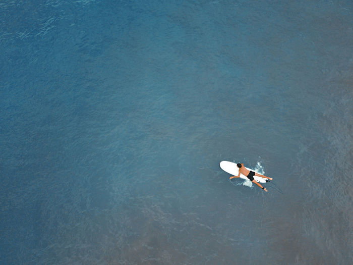 A surfer on a board from above