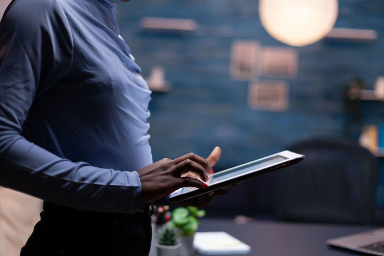 Midsection of man using mobile phone