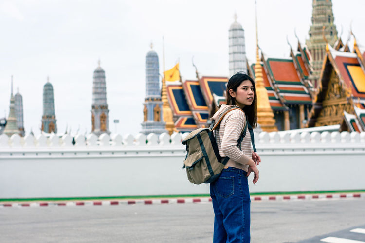 Portrait of young woman standing in city, woman backpacking to thailand on holiday