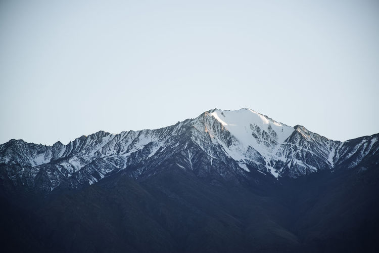 Scenic view of snowcapped mountains against clear sky
