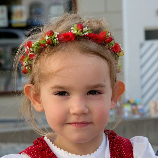 Close-up portrait of girl wearing flowers on hair
