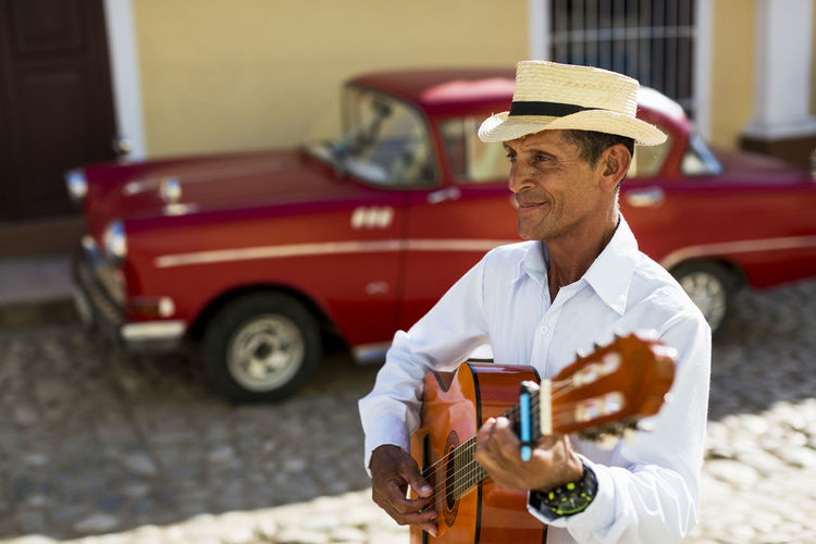 Cuba, trinidad, man playing guitar on the street