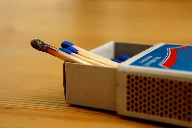 Close-up of sticks in matchbox on table