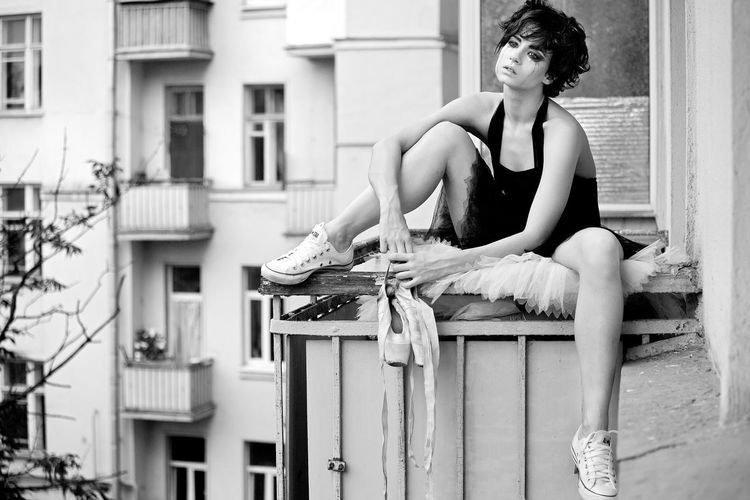 The ballerina sits on the balcony and thinks they haven't changed their shoes.