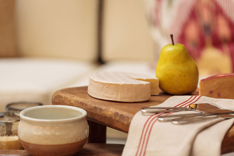 Close-up of cheese and pear with napkin on cutting board