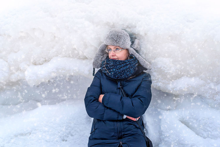 Woman on the background of a winter landscape with large hummocks, frozen ice, jurmala, latvia. 