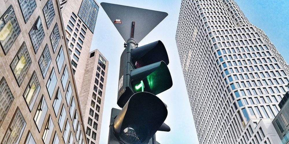 Low angle view of road signal against buildings 