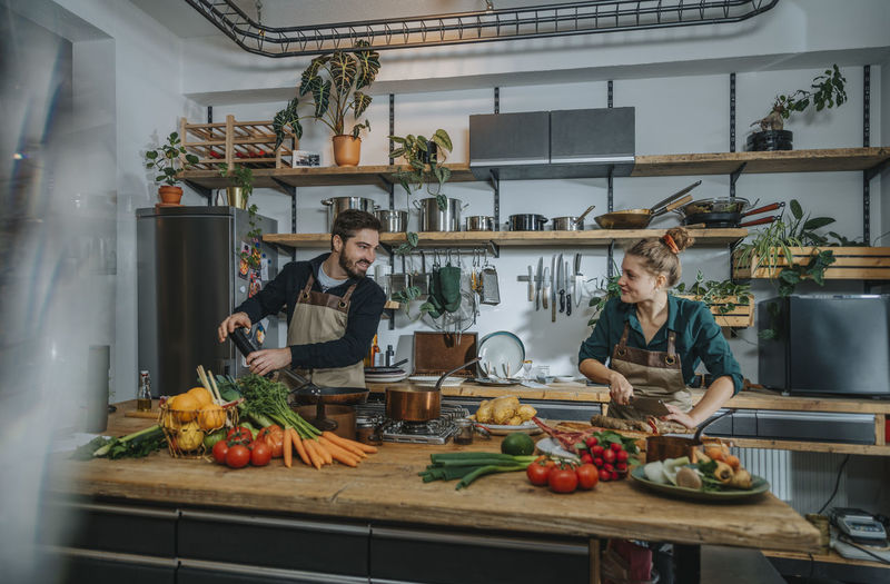 Chefs smiling while working in kitchen